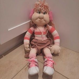 Adorable posable doll dressed in pink and wearing Adidas shoes